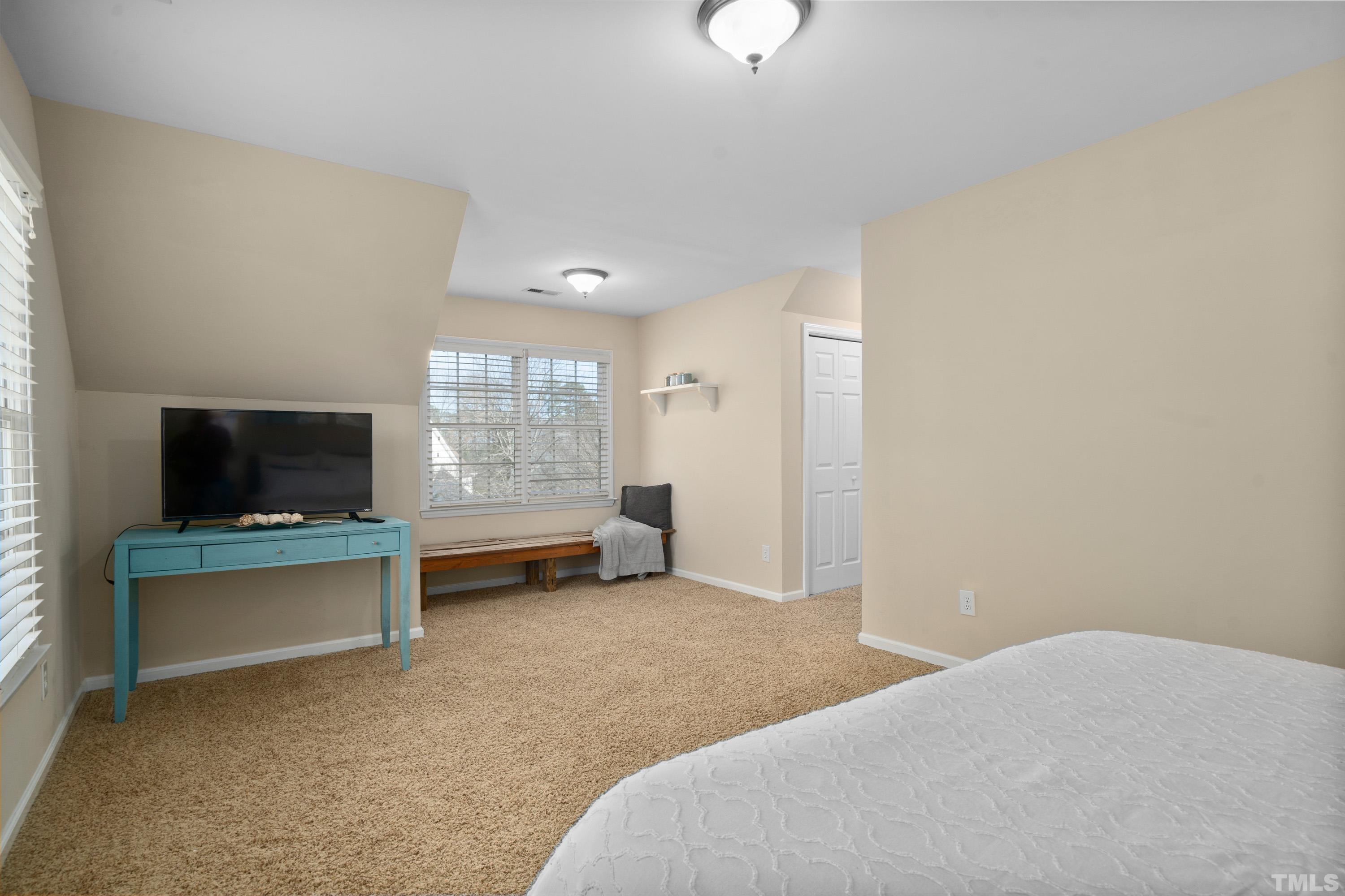 7405 Dorrington Trail Raleigh, NC 27615 - Photo 26 of 31 a bedroom with furniture and a flat screen tv
