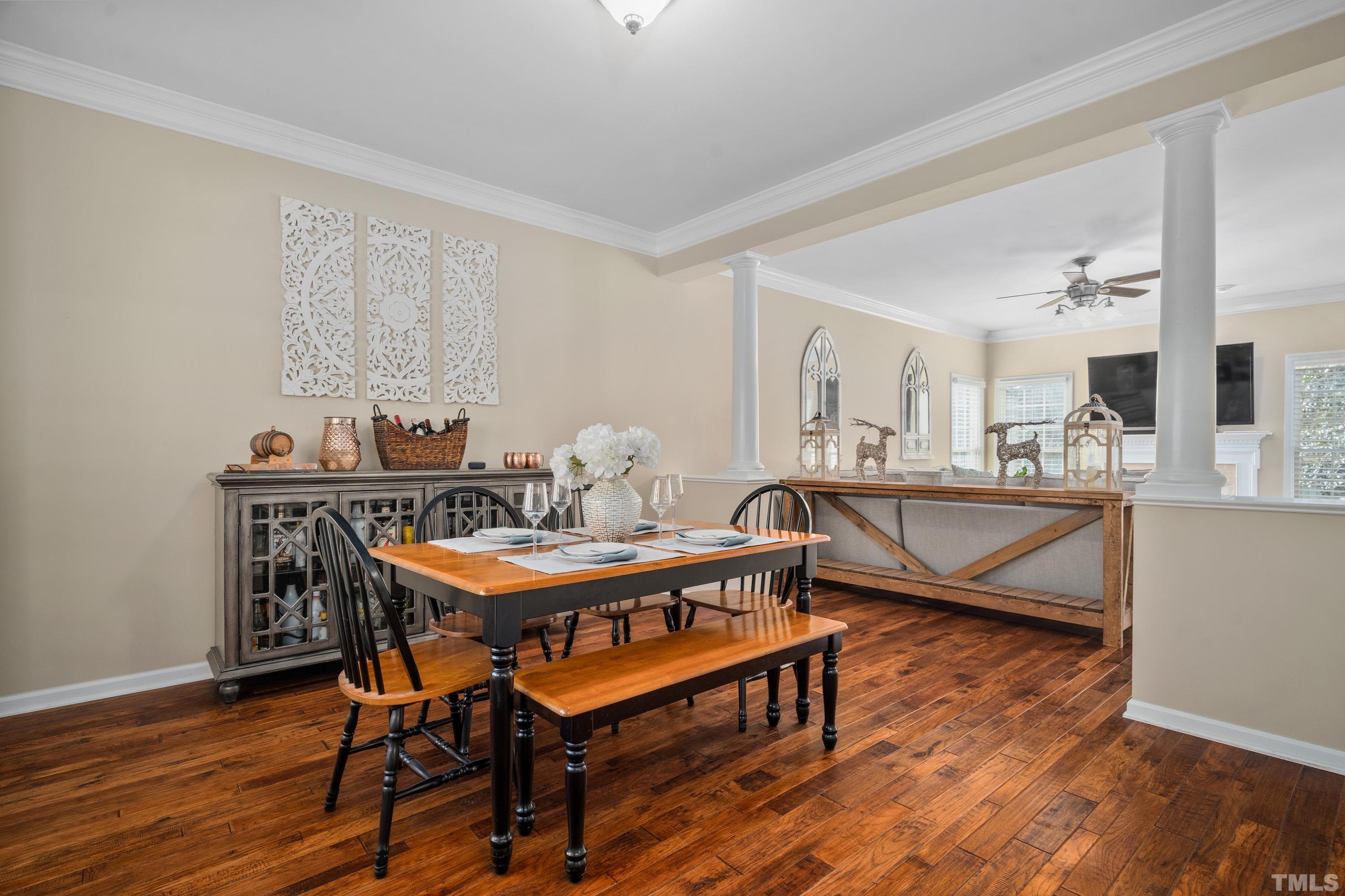 7405 Dorrington Trail Raleigh, NC 27615 - Photo 8 of 31 a dining room with furniture a rug and wooden floor