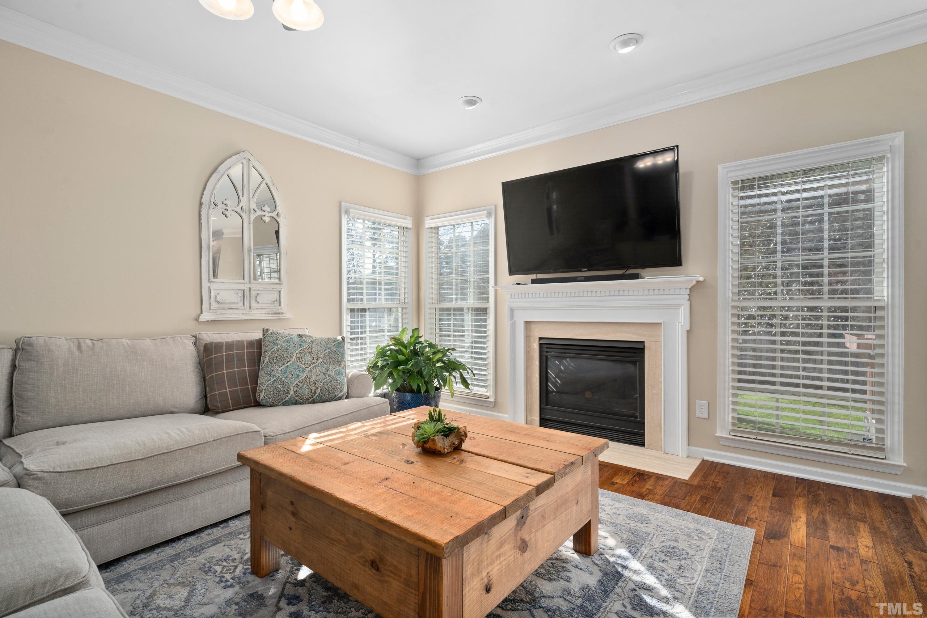 7405 Dorrington Trail Raleigh, NC 27615 - Photo 9 of 31 a living room with furniture fireplace and flat screen tv