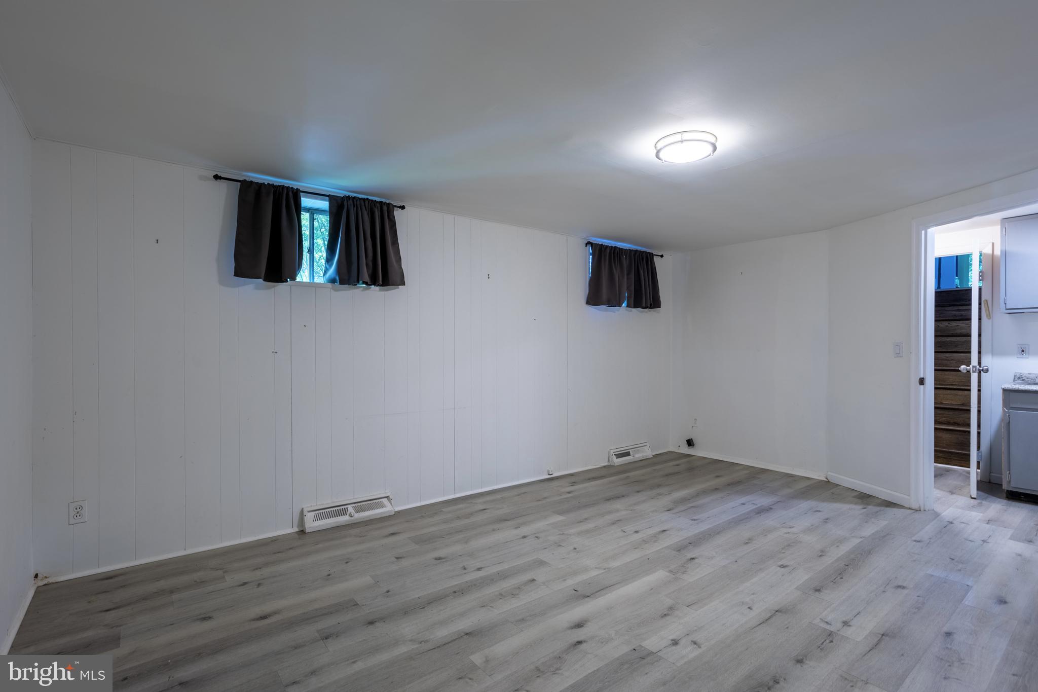 3207 Midfield Road Pikesville, MD 21208 - Photo 33 of 45 a view of empty room with wooden floor and fan
