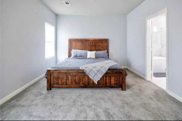 a bedroom with a bed and a window