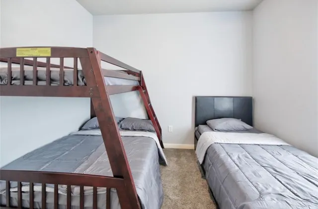 a bedroom with a bed and lamp