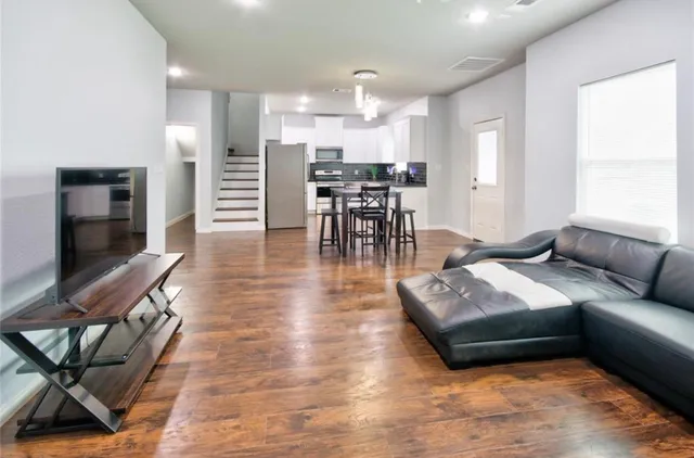 a living room with furniture and kitchen view
