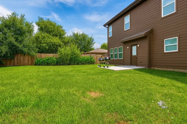 a view of a house with a yard and sitting area