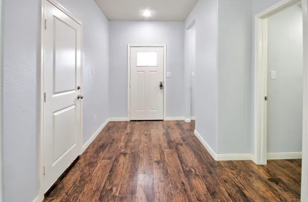 a view of a room with wooden floor