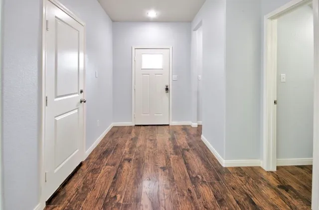a view of a room with wooden floor