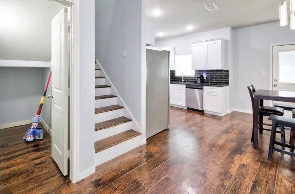 a view of a kitchen and wooden floor