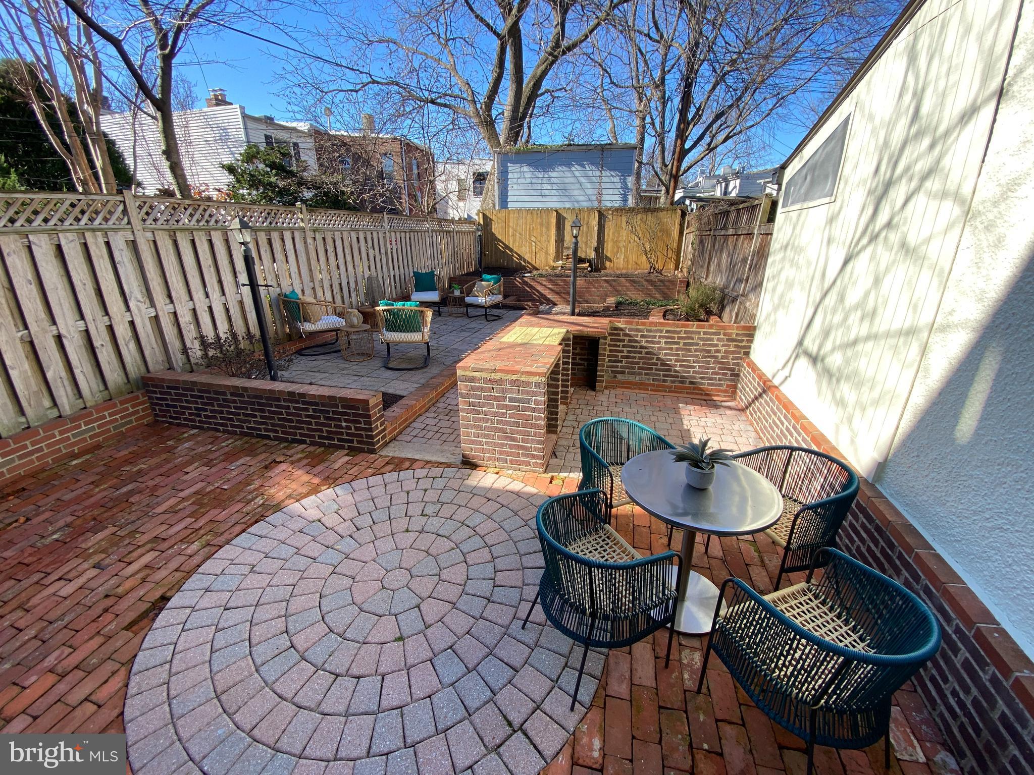 a view of a chairs and tables in the back yard of the house