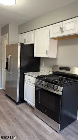 a kitchen with stainless steel appliances a stove a microwave and a refrigerator