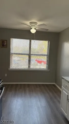 a view of room with window and wooden floor