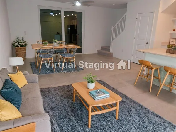 a living room with furniture a rug and a table