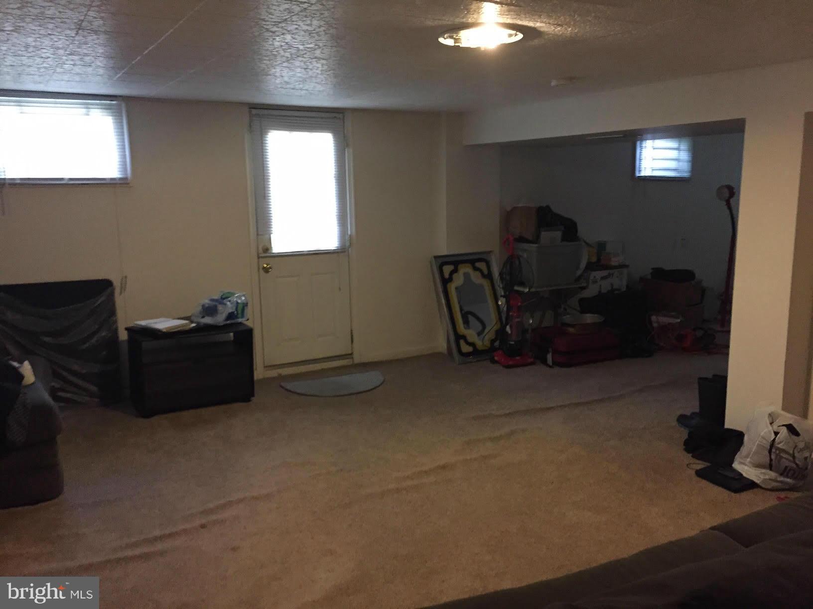 731 Stamford Road Baltimore, MD 21229 - Photo 8 of 9 a living room with furniture a flat screen tv and a window
