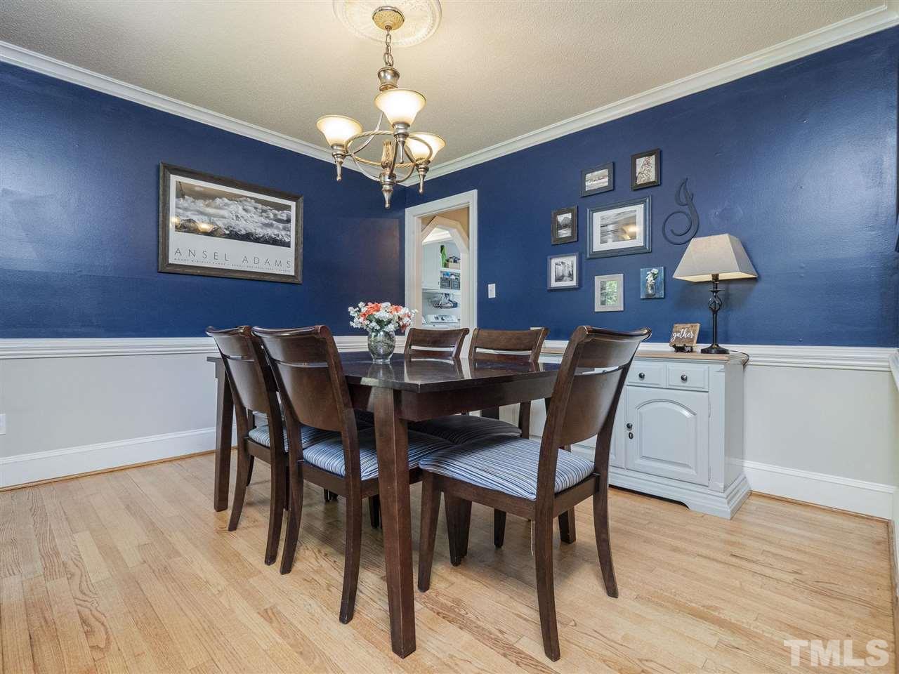 6108 Bur Trail Raleigh, NC 27616 - Photo 11 of 30 a view of a dining room with furniture wooden floor and chandelier