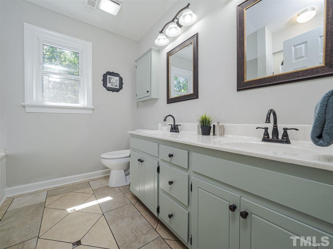 6108 Bur Trail Raleigh, NC 27616 - Photo 15 of 30 a bathroom with a toilet sink and mirror