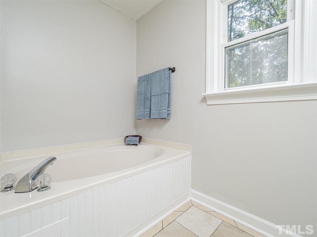 6108 Bur Trail Raleigh, NC 27616 - Photo 16 of 30 a white bath tub sitting next to a window