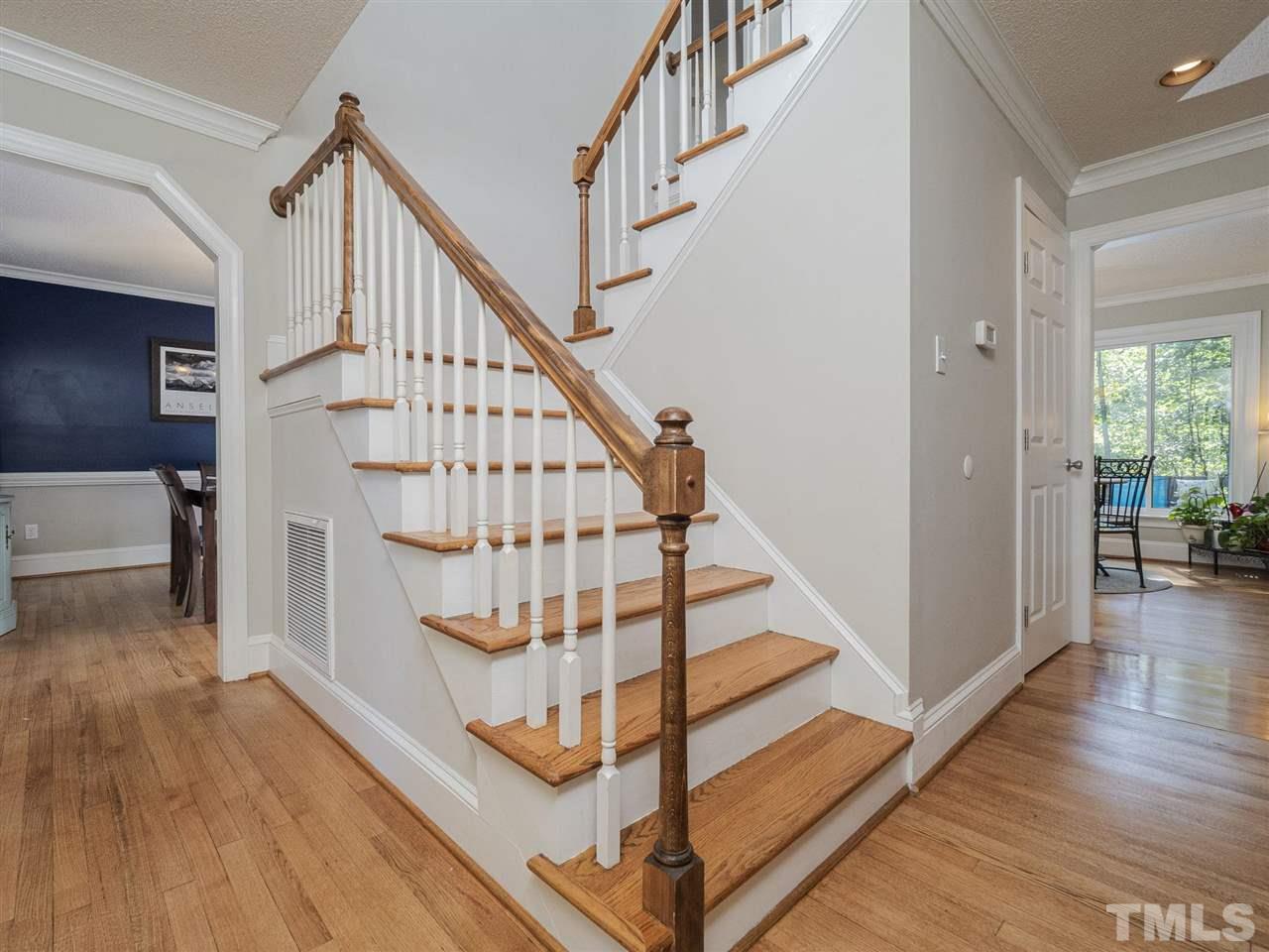 6108 Bur Trail Raleigh, NC 27616 - Photo 4 of 30 a view of entryway with wooden floor and stairs