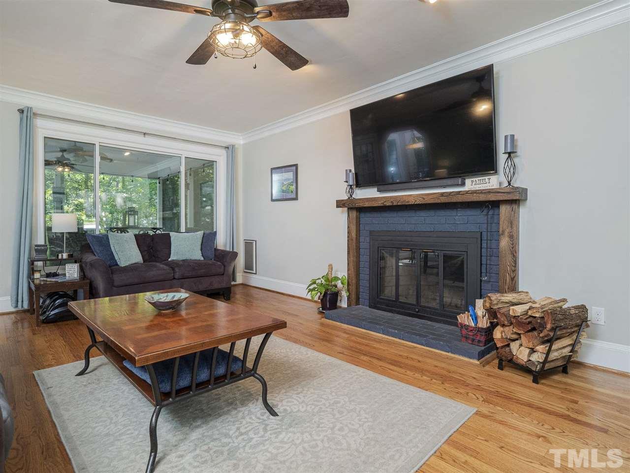 6108 Bur Trail Raleigh, NC 27616 - Photo 5 of 30 a living room with furniture a flat screen tv and a fireplace