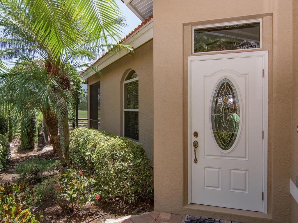 104 Napa Ridge Way Naples, FL 34119 - Photo 11 of 29 a front view of a house with garden