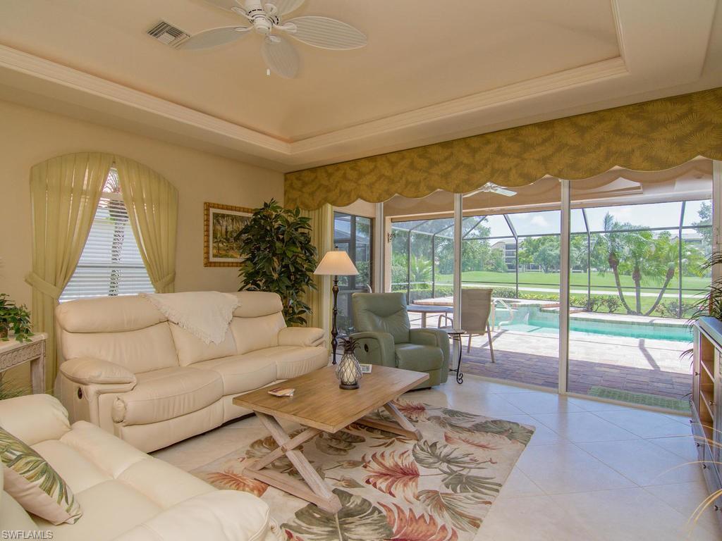 104 Napa Ridge Way Naples, FL 34119 - Photo 13 of 29 a living room with furniture and a large window