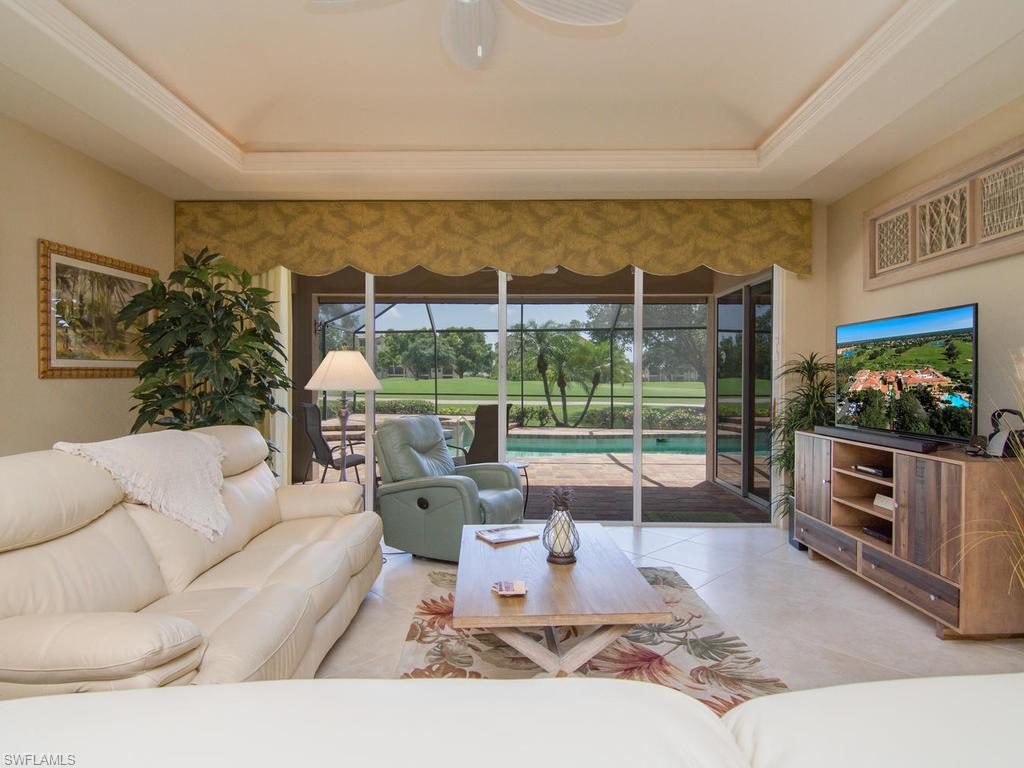 104 Napa Ridge Way Naples, FL 34119 - Photo 14 of 29 a living room with furniture and a flat screen tv