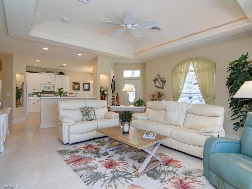 104 Napa Ridge Way Naples, FL 34119 - Photo 15 of 29 a living room with furniture and a view of kitchen