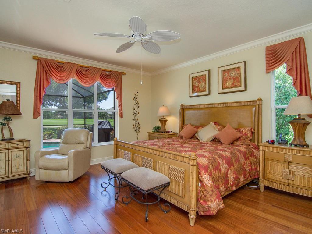 104 Napa Ridge Way Naples, FL 34119 - Photo 18 of 29 a bedroom with a bed and a couch