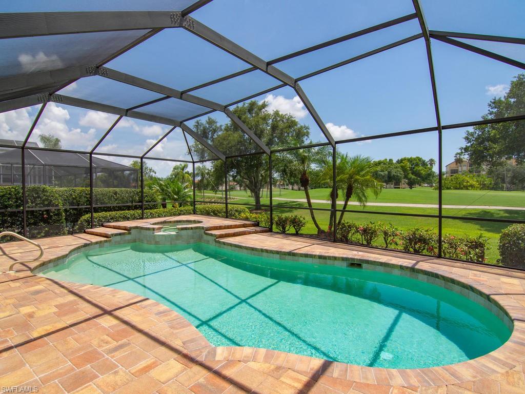 104 Napa Ridge Way Naples, FL 34119 - Photo 5 of 29 a view of a backyard with sitting area