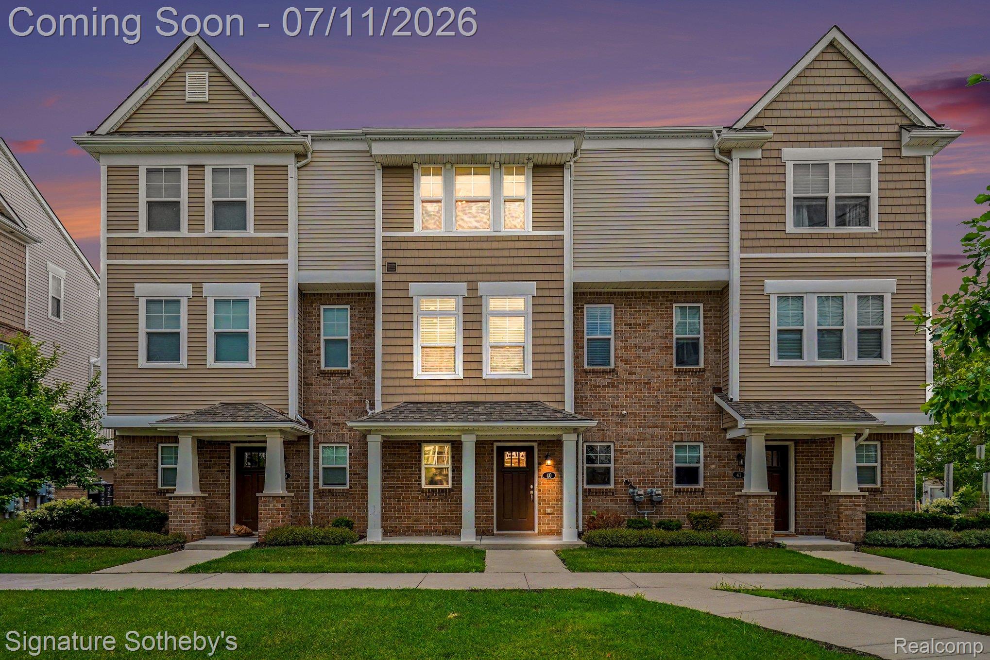 2500 Normandy Road, Unit 40 Royal Oak, MI 48073 - Photo 1 of 26 Multi-story townhome exterior featuring a combination of brick and siding, covered front entryways, and manicured green lawns