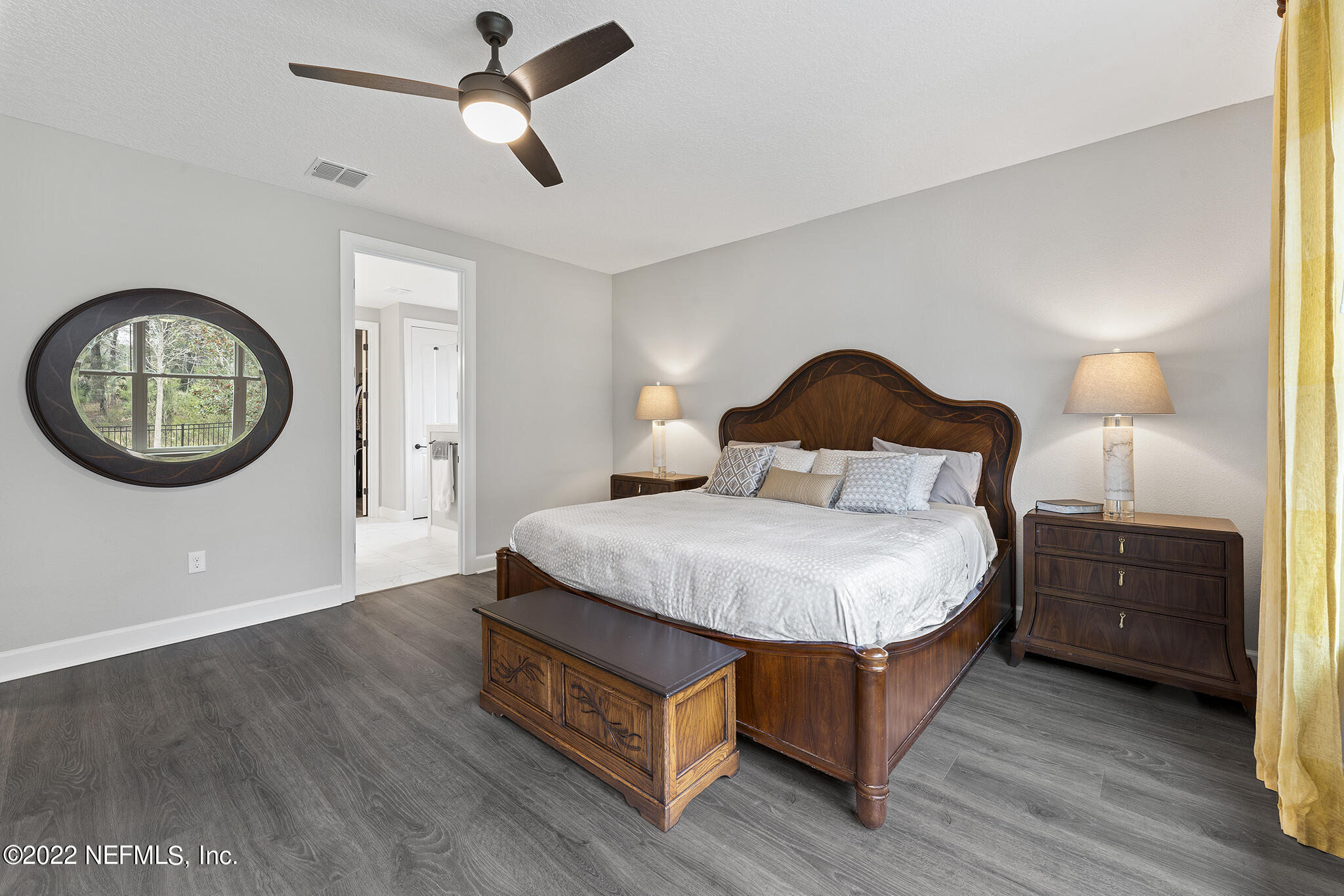 211 Orchard Lane St. Augustine, FL 32095 - Photo 25 of 59 a bedroom with a bed a mirror and a large window