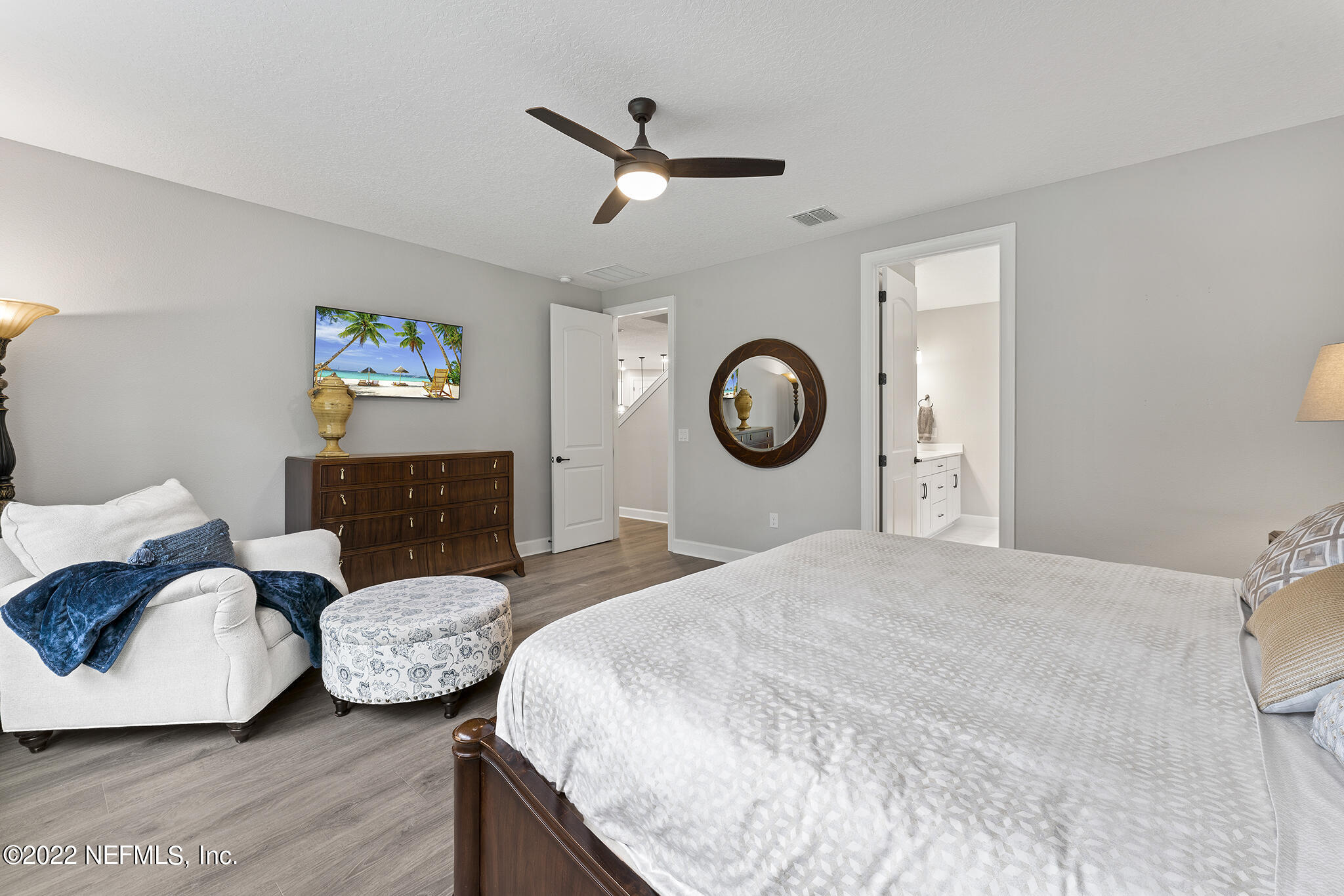 211 Orchard Lane St. Augustine, FL 32095 - Photo 26 of 59 a bedroom with a bed and a chandelier