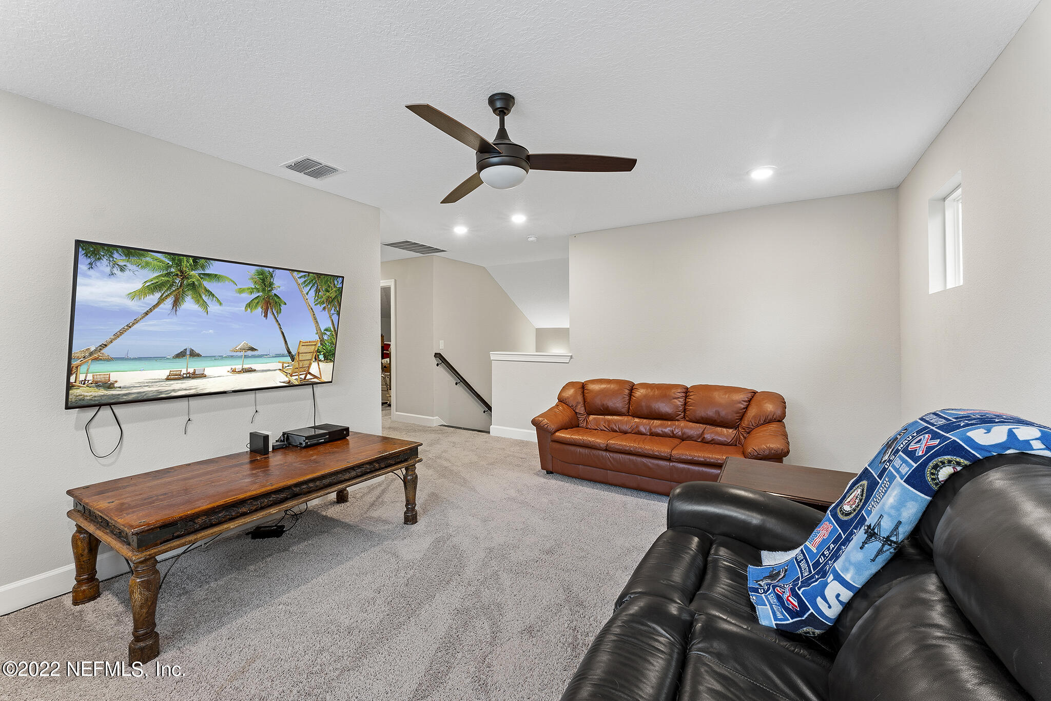 211 Orchard Lane St. Augustine, FL 32095 - Photo 31 of 59 a living room with furniture and a flat screen tv