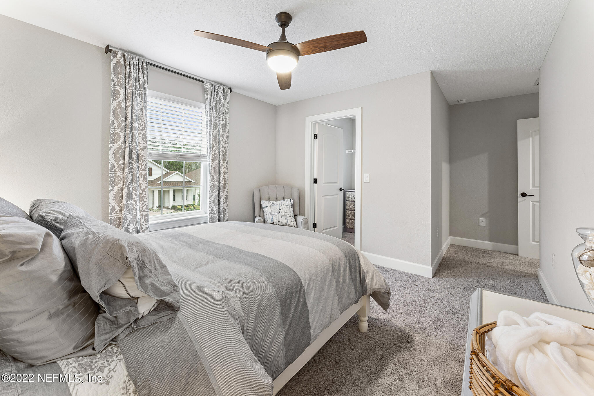 211 Orchard Lane St. Augustine, FL 32095 - Photo 34 of 59 a bedroom with a bed and a chandelier