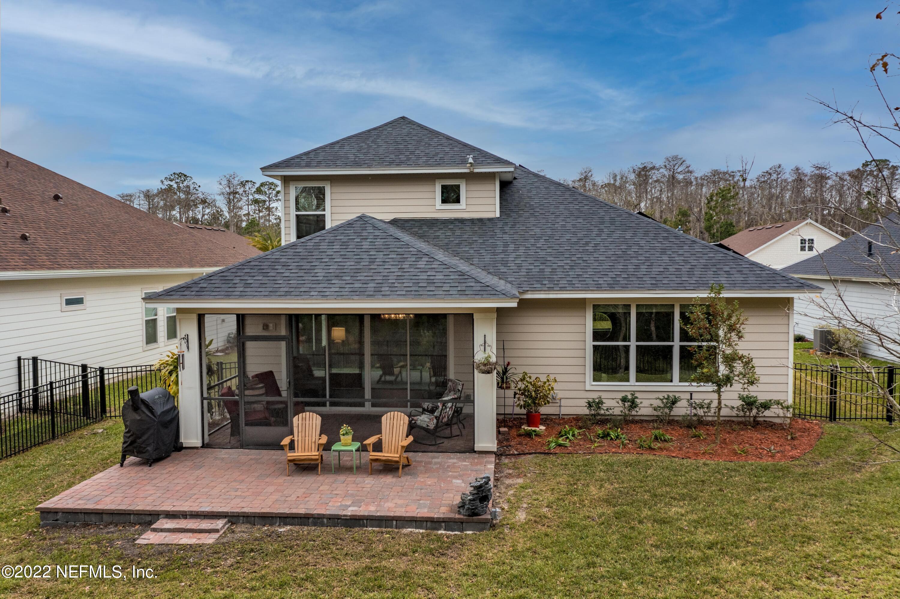 211 Orchard Lane St. Augustine, FL 32095 - Photo 43 of 59 a view of a house with floor to ceiling window and outdoor kitchen