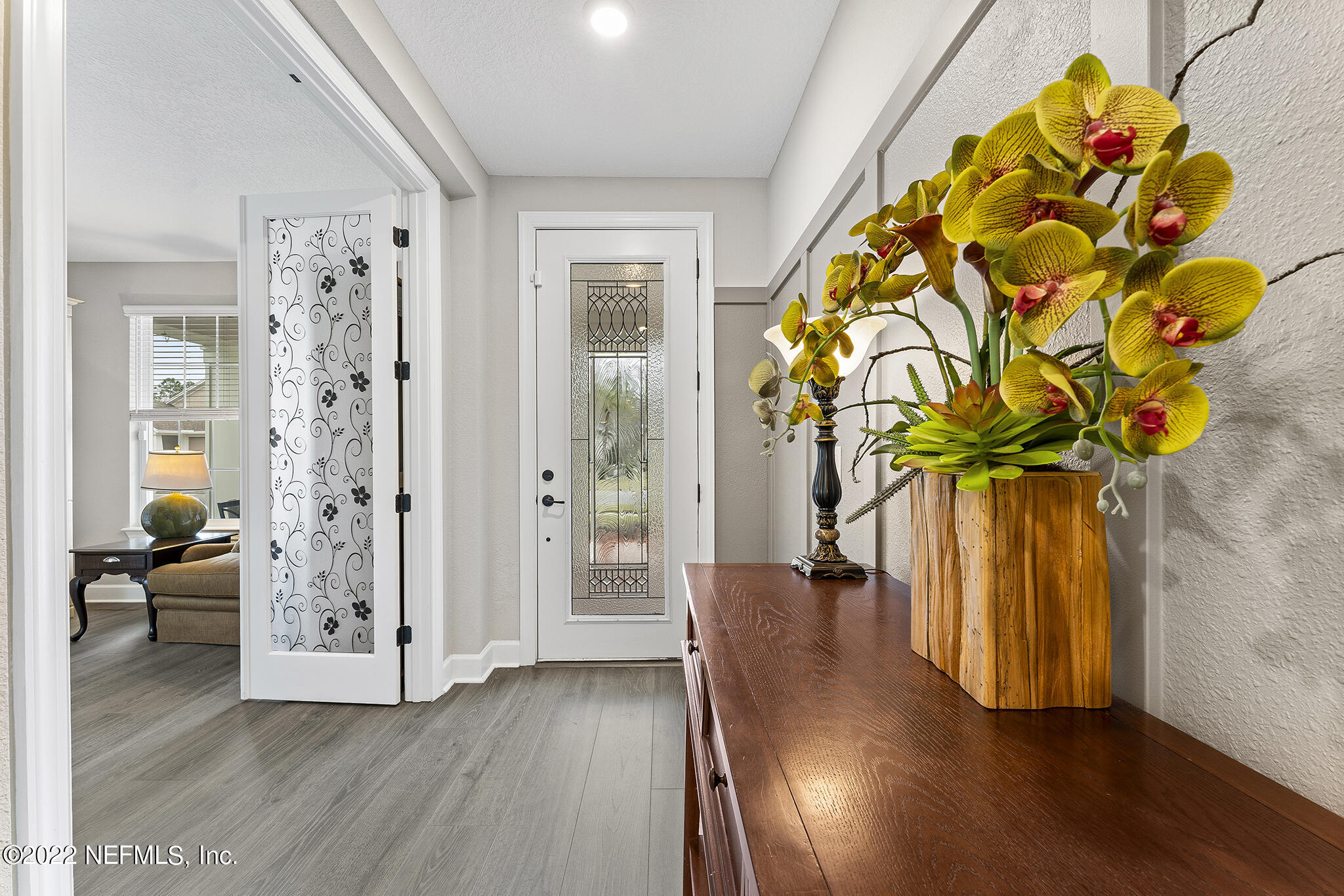 211 Orchard Lane St. Augustine, FL 32095 - Photo 6 of 59 a view of a hallway with wooden floor and windows