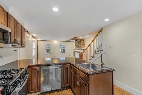 a kitchen with sink stove and cabinets