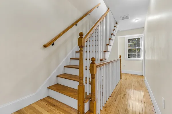 a view of entryway with wooden floor and stairs