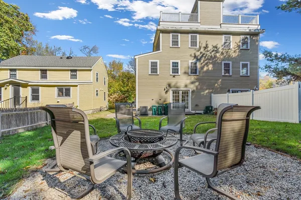 a view of a patio with couches chairs and a fire pit