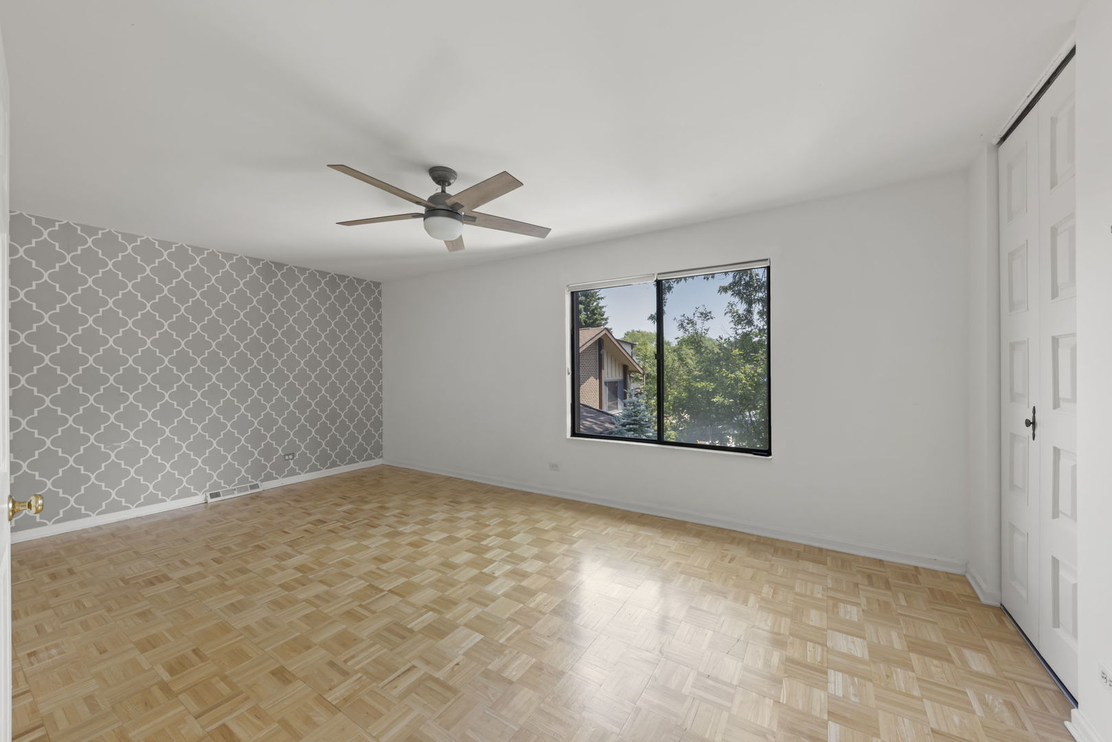 698 Circle Drive Roselle, IL 60172 - Photo 18 of 31 an empty room with windows and fan