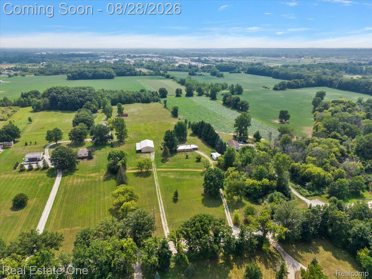 15250 34 Mile Road Armada, MI 48005 - Photo 12 of 49 Expansive rural setting with multiple structures, broad open fields, and mature trees throughout