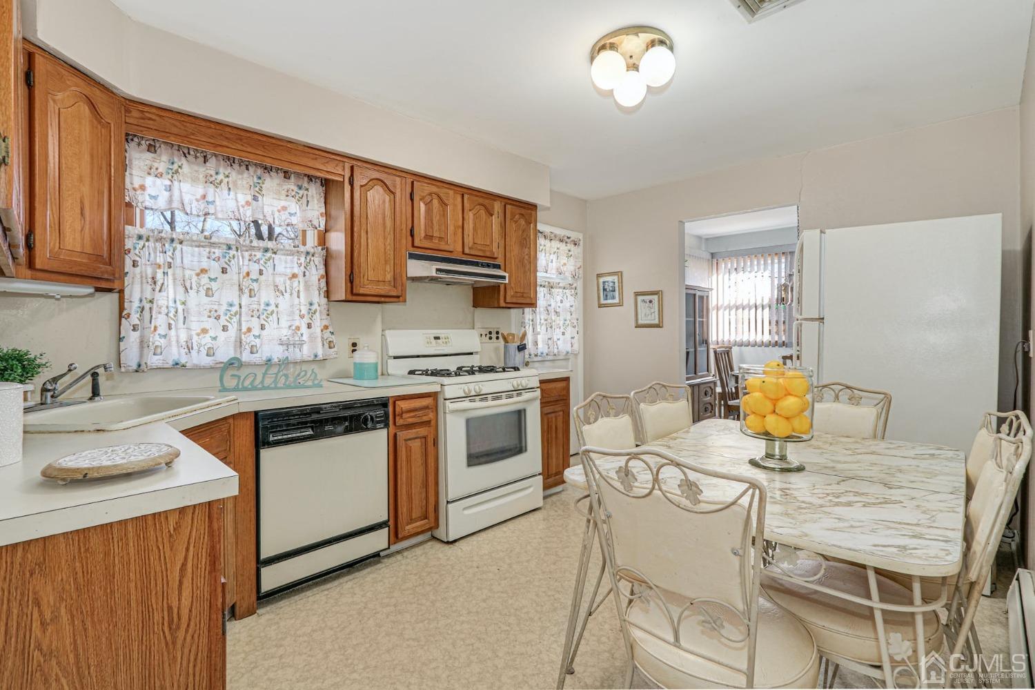 22 Morningside Road Colonia, NJ 07067 - Photo 14 of 31 a kitchen with a stove a sink a kitchen island a stove and a window