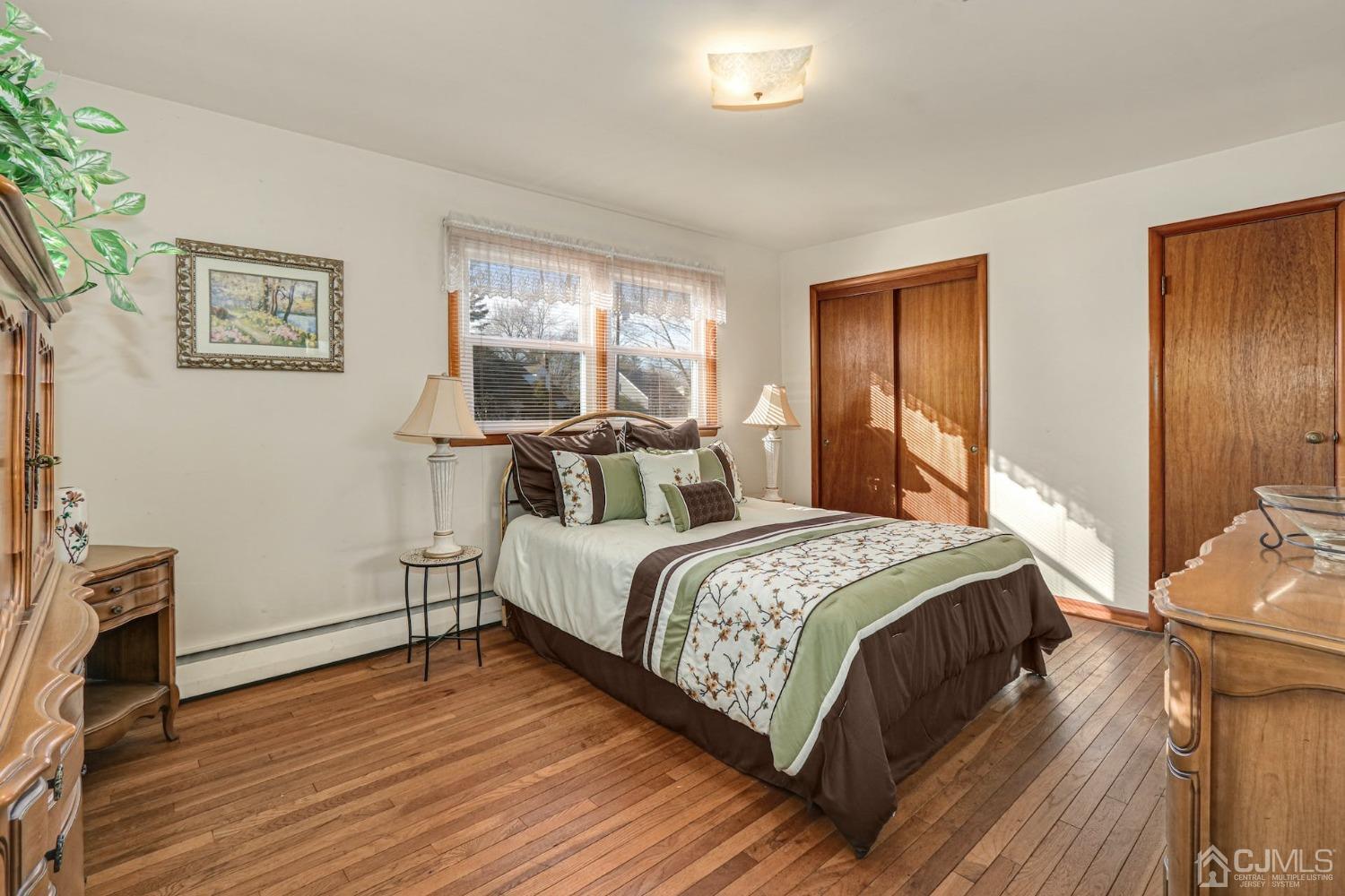 22 Morningside Road Colonia, NJ 07067 - Photo 16 of 31 a bedroom with a bed and wooden floor