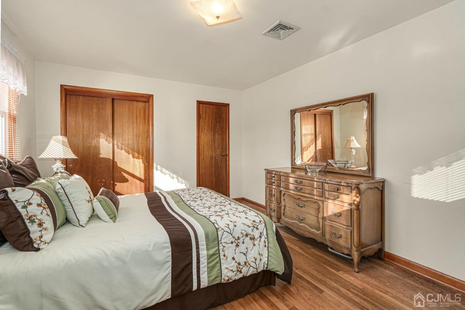 22 Morningside Road Colonia, NJ 07067 - Photo 17 of 31 a bedroom with a bed and wooden floor