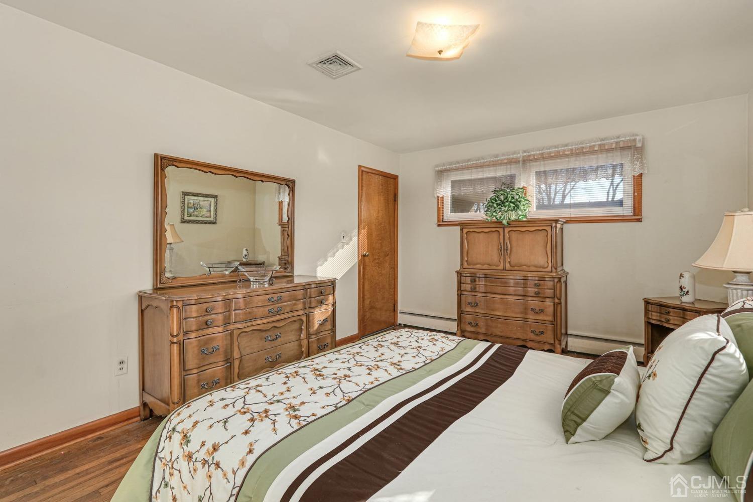 22 Morningside Road Colonia, NJ 07067 - Photo 19 of 31 a bedroom with a bed and dresser with mirror