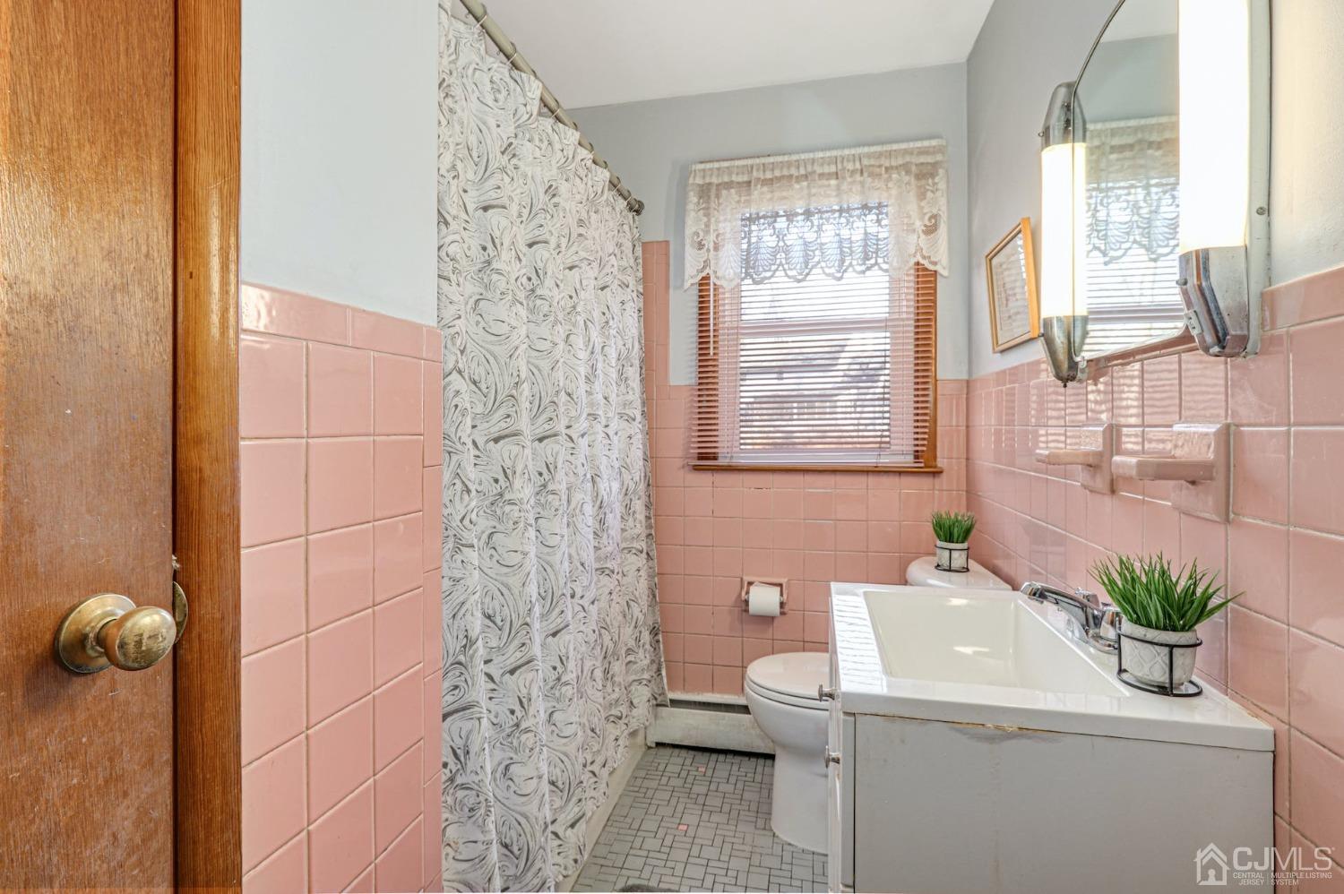 22 Morningside Road Colonia, NJ 07067 - Photo 24 of 31 a bathroom with a sink a toilet and a shower