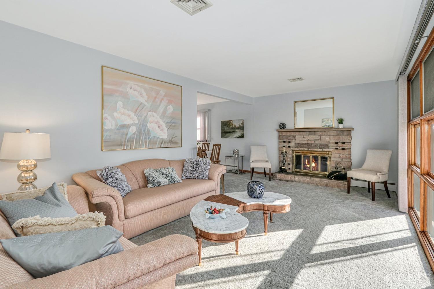22 Morningside Road Colonia, NJ 07067 - Photo 6 of 31 a living room with furniture a fireplace and a table