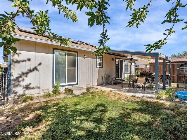 a view of house with backyard porch and sitting area