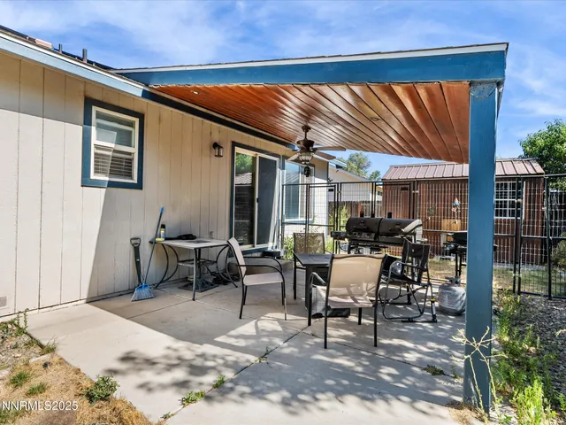 a view of a house with backyard sitting area and garden