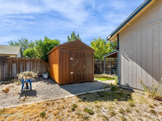 a backyard of house with wooden fence