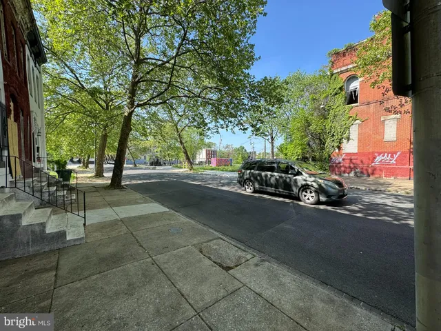 a view of street with parked cars