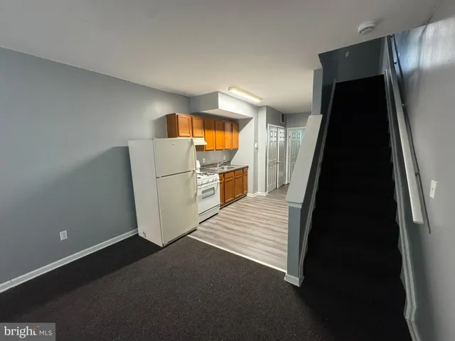 a kitchen with a white cabinets and white appliances